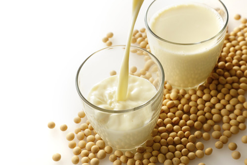 中国産の大豆が入ったグラスに牛乳が注がれています。