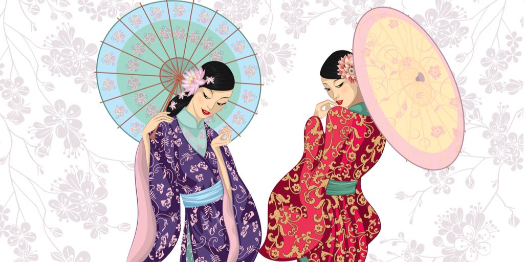 中国の着物を着た 2 人の女性が傘を持っています。