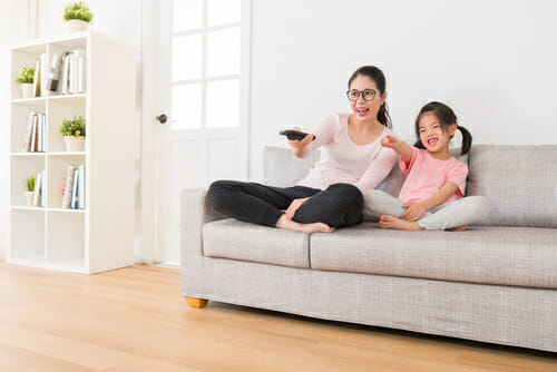 中国でソファに座ってテレビを見ている母と娘。