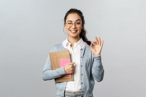 中国でフォルダーを持ち、OKサインを示す若い女性。