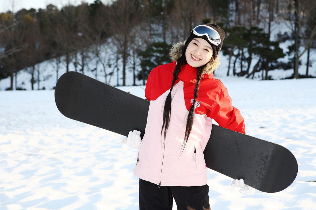 一人の娘が雪の中で滑走板を握った。
