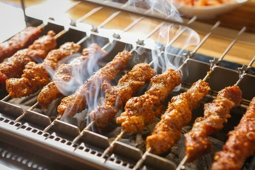 グリルで焼かれた中国風串と煙が出ています。