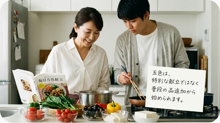 家庭の台所でブロッコリーやミニトマトや卵焼きを使った五色弁当を準備する様子